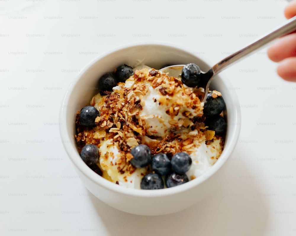 a bowl filled with yogurt and blueberries