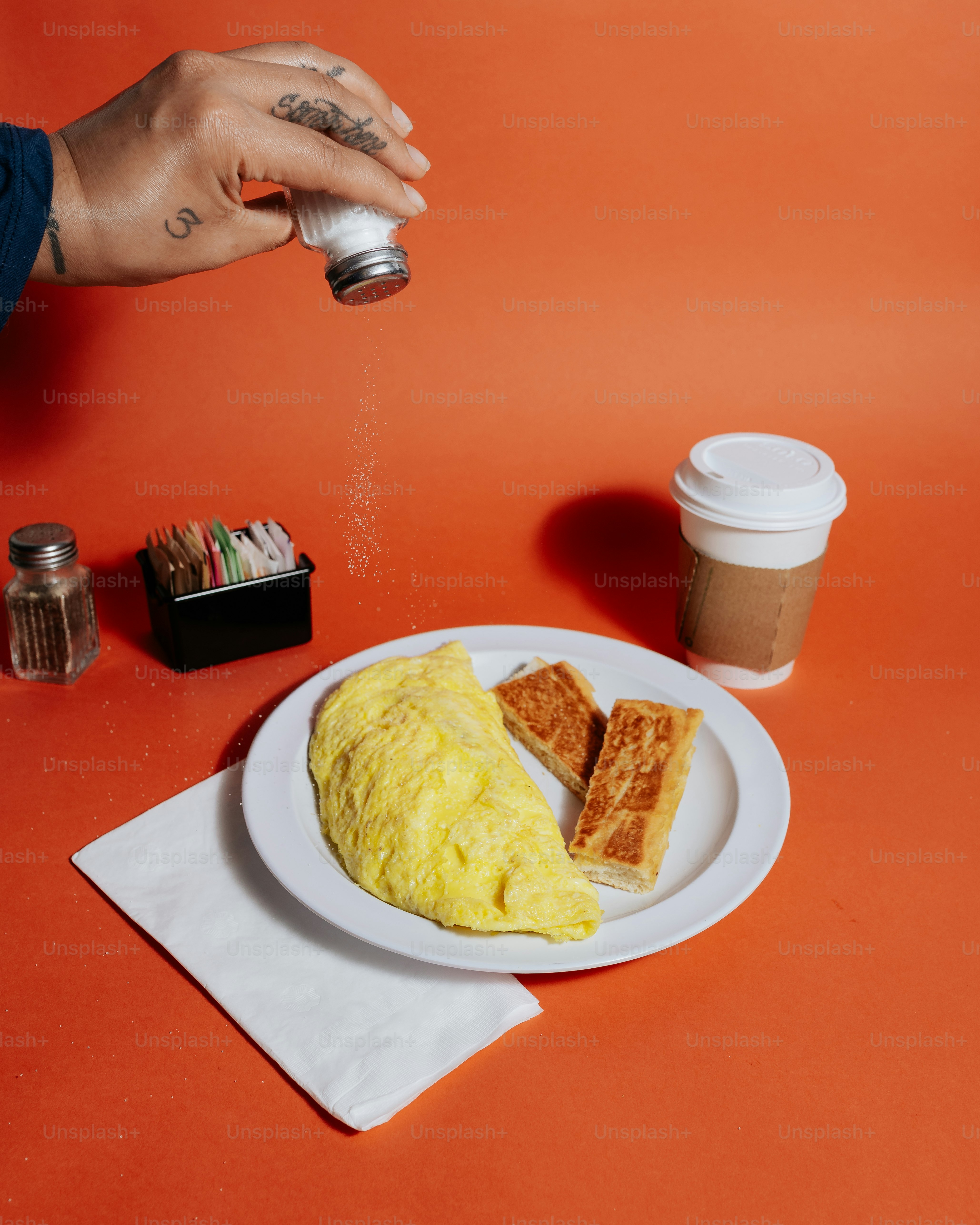 a person is sprinkling sugar on a plate of food