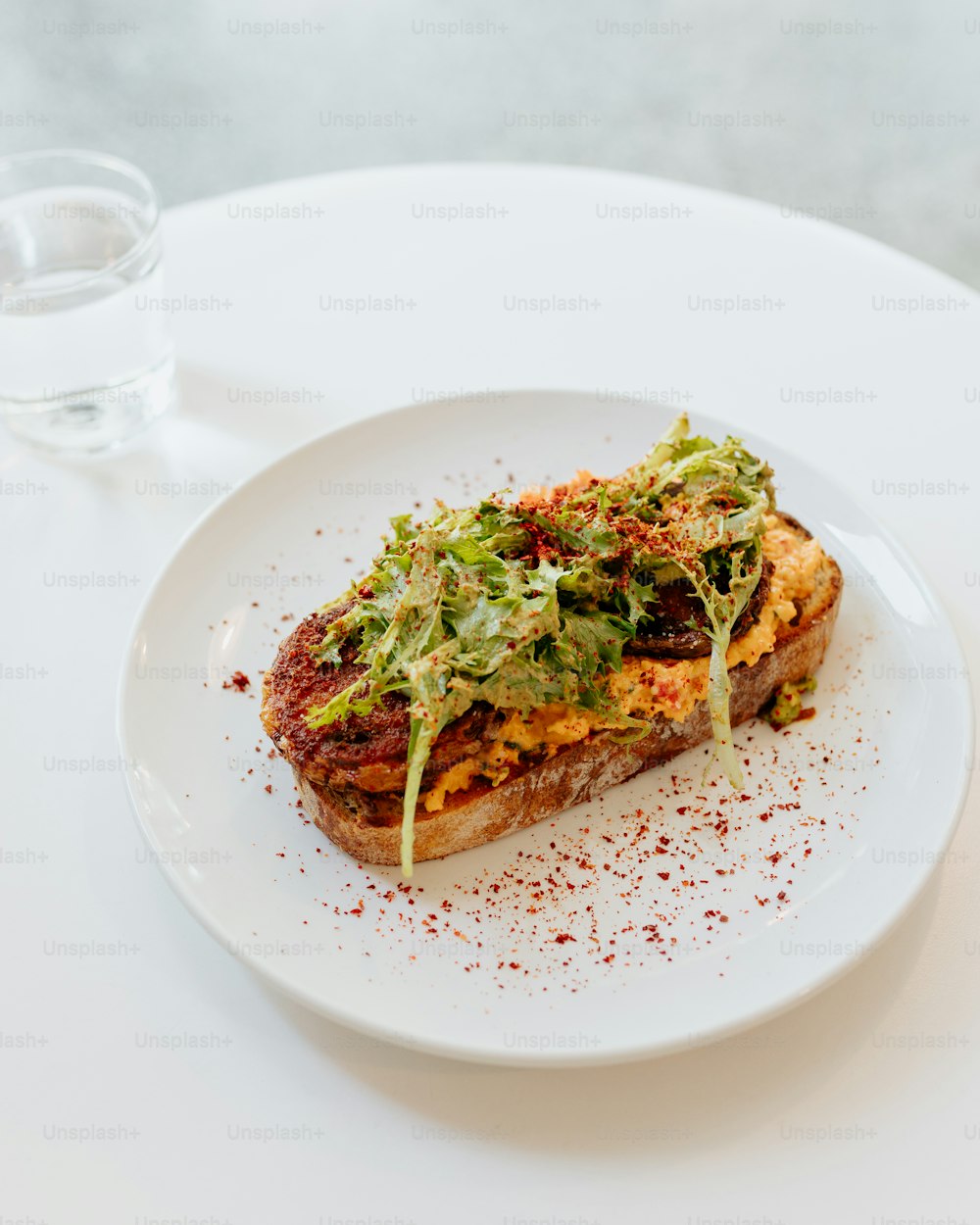 a white plate topped with a piece of food