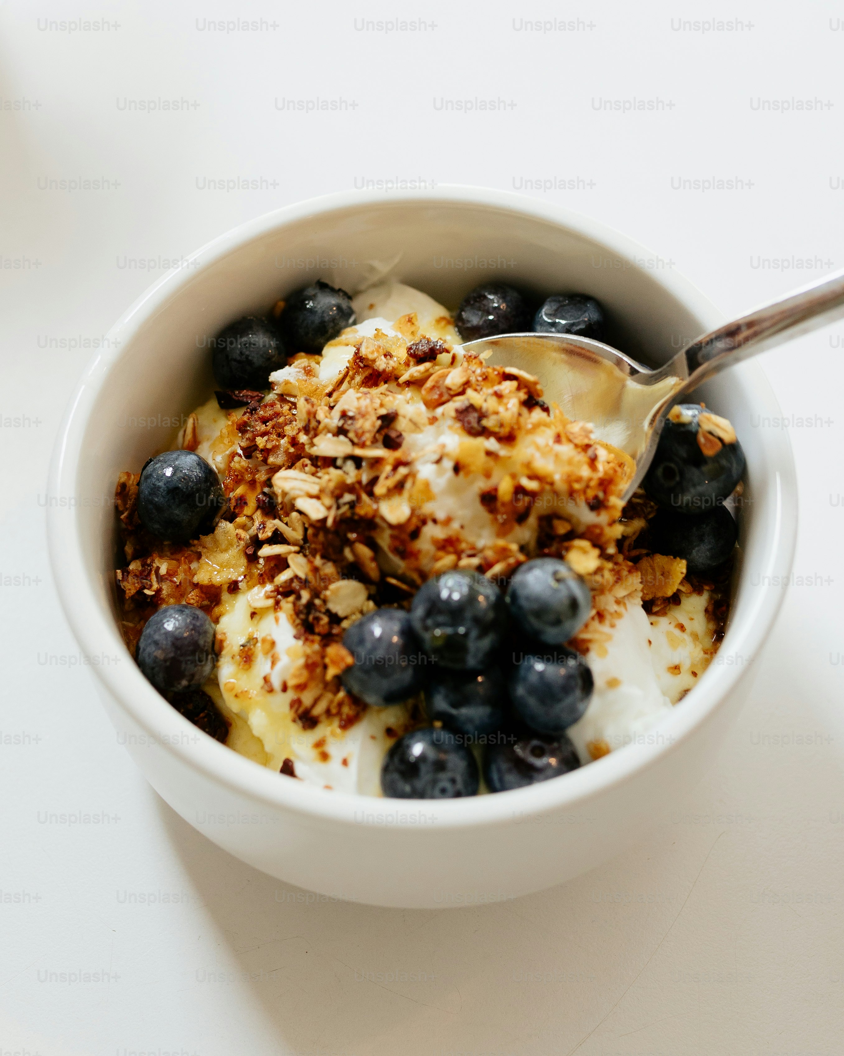 a bowl of yogurt with blueberries and granola