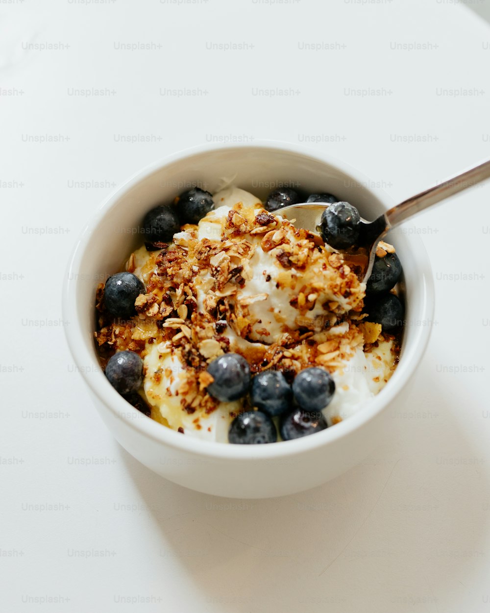 a bowl of yogurt with blueberries and granola