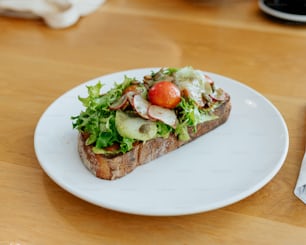 a white plate topped with a cut in half sandwich