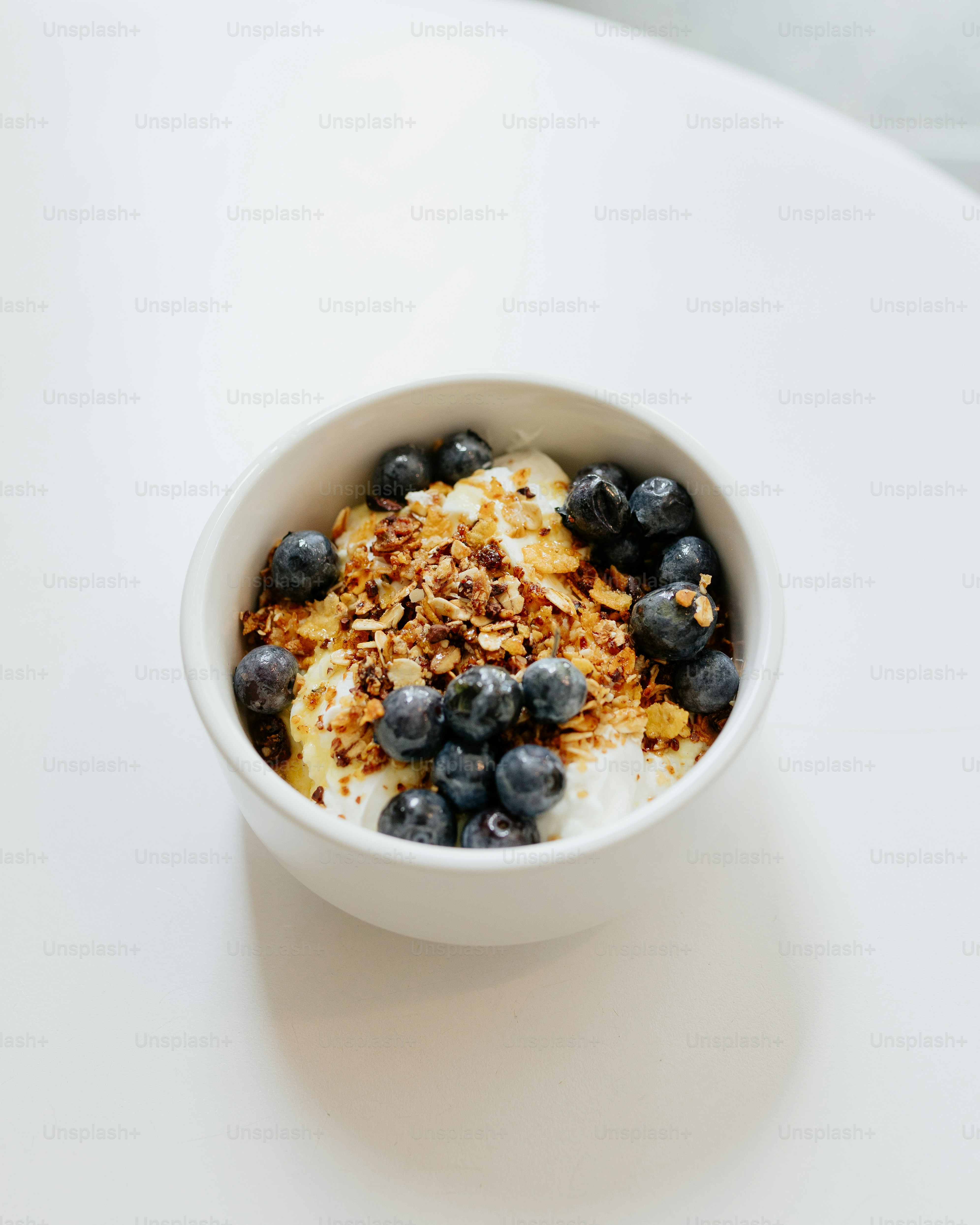 a bowl of cereal with blueberries and granola