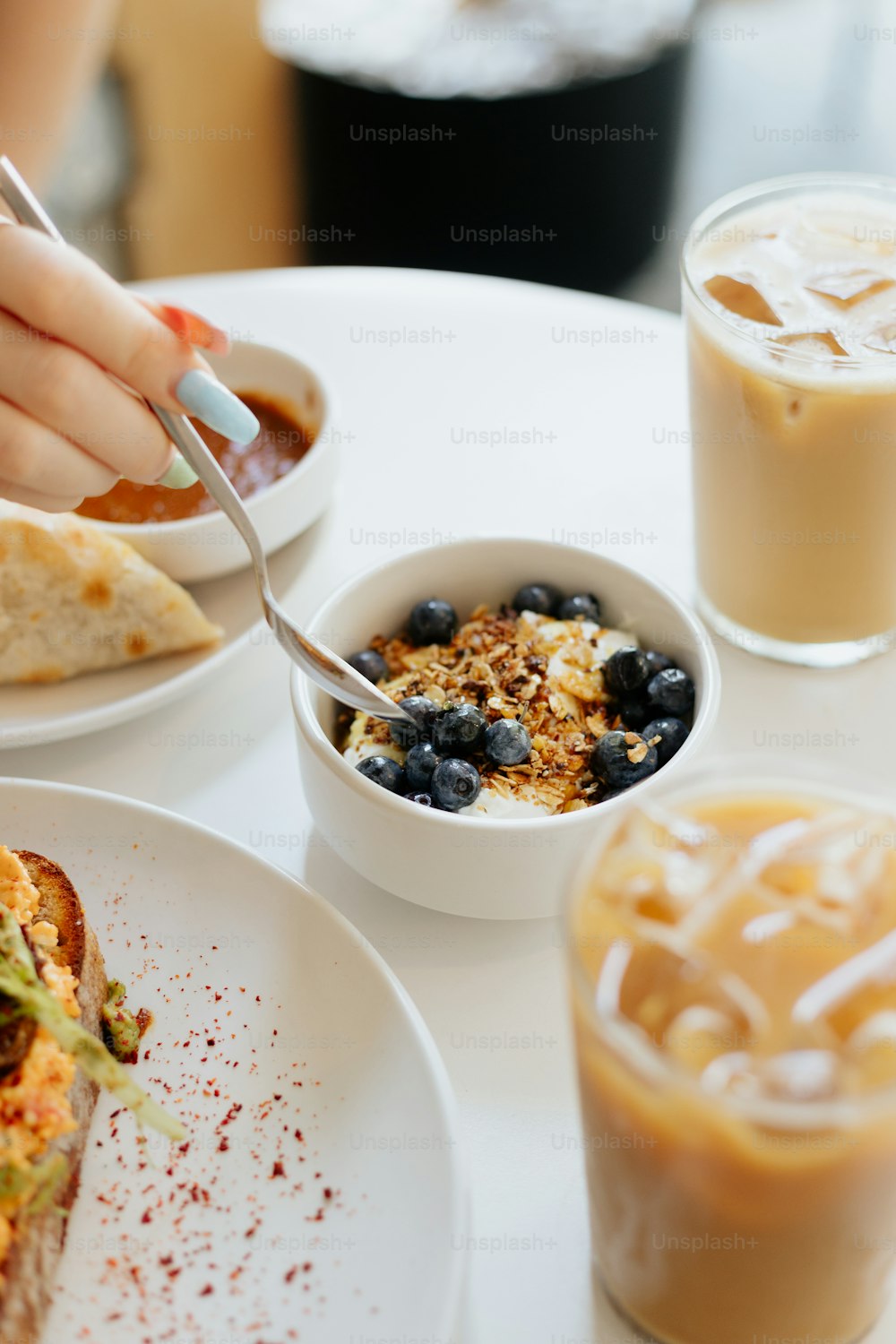 a table with a plate of food and a cup of coffee