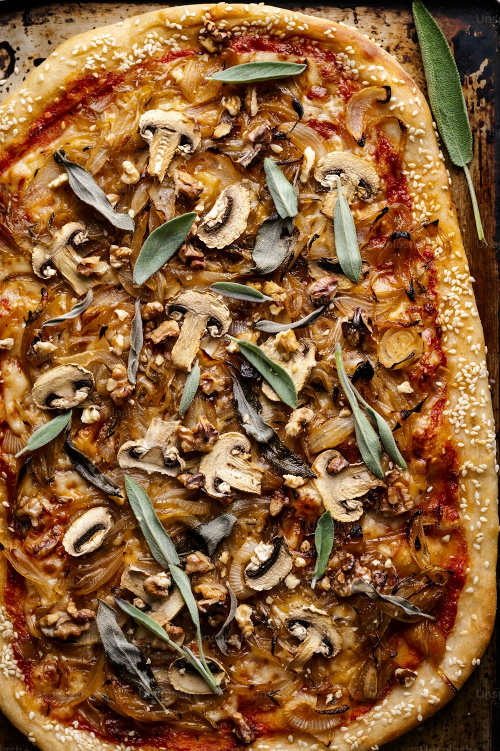 a pizza with mushrooms on top of it on a pan