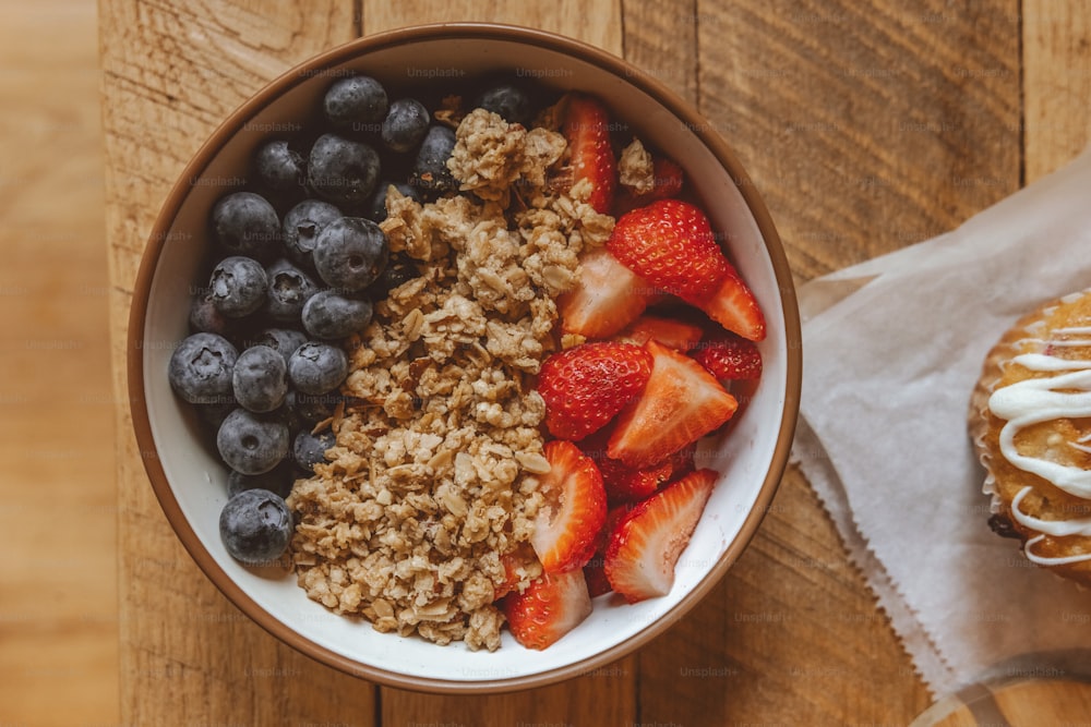 a bowl of oatmeal with strawberries and blueberries