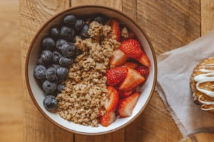 a bowl of oatmeal with strawberries and blueberries