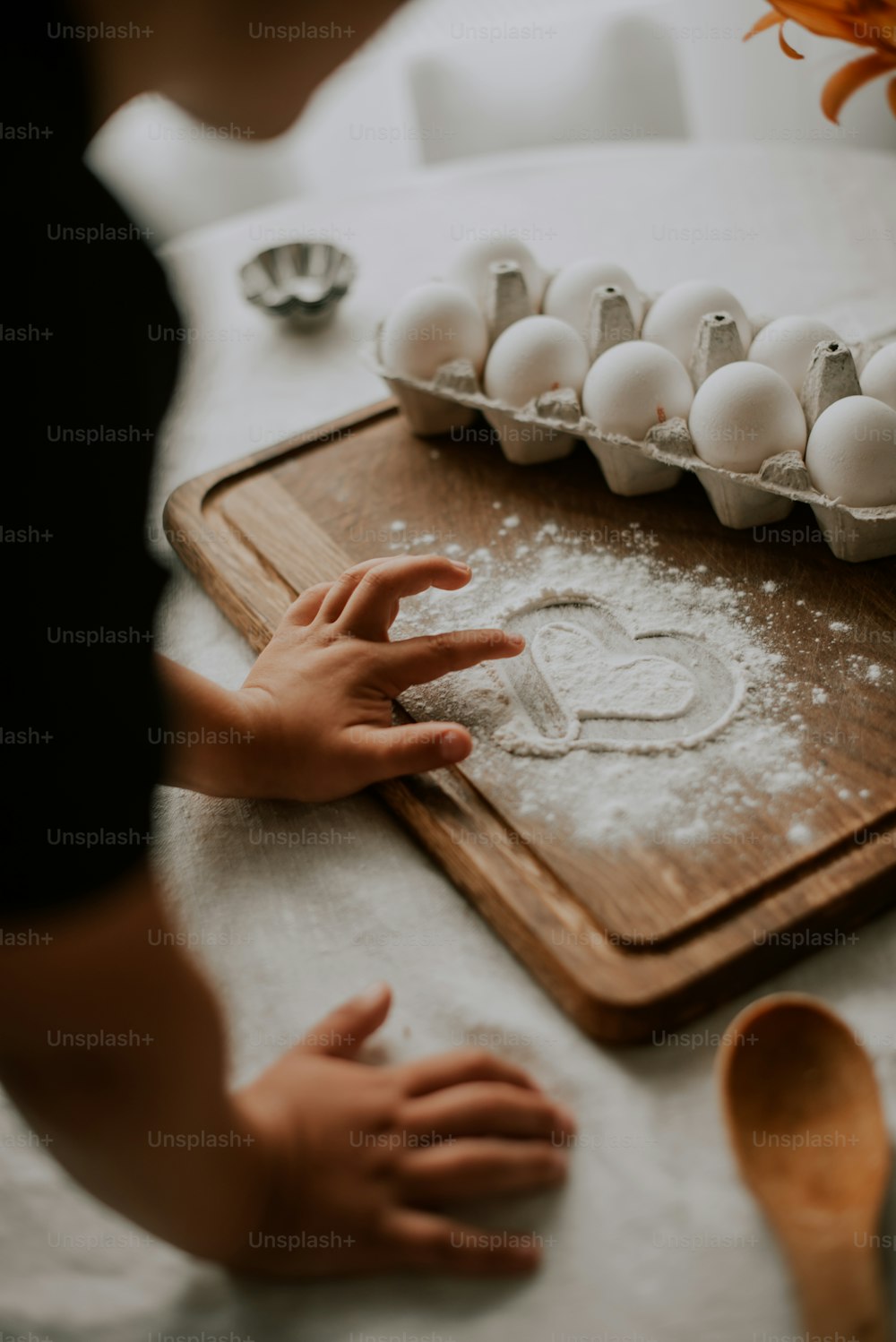 a person standing over a cutting board with eggs on it