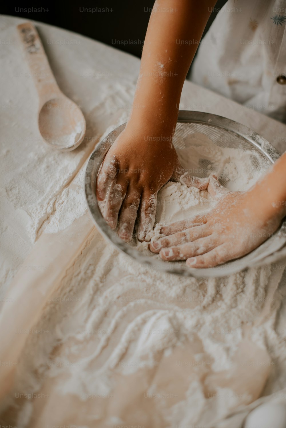 a person is kneading dough in a bowl