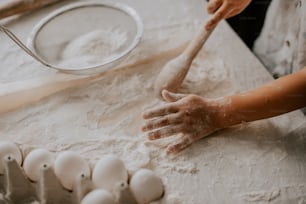 a person is kneading dough on a table