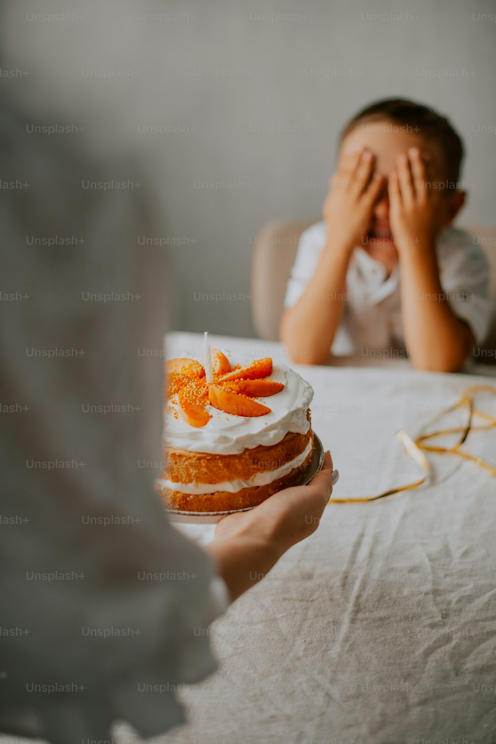 a person holding a cake with oranges on it