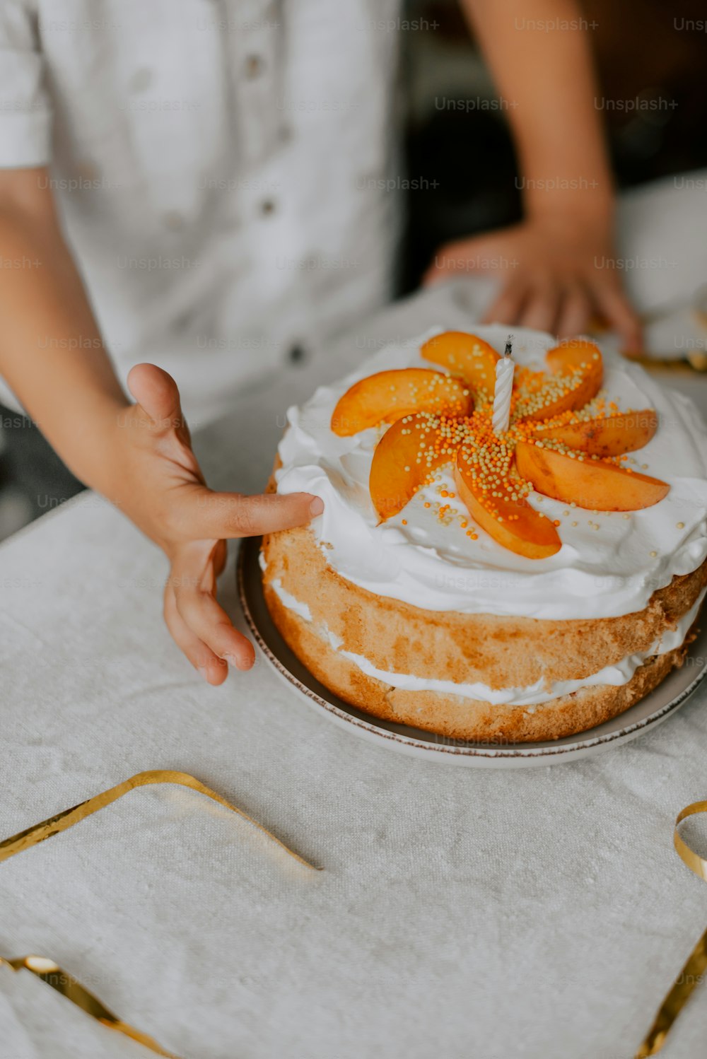 a person is decorating a cake on a table