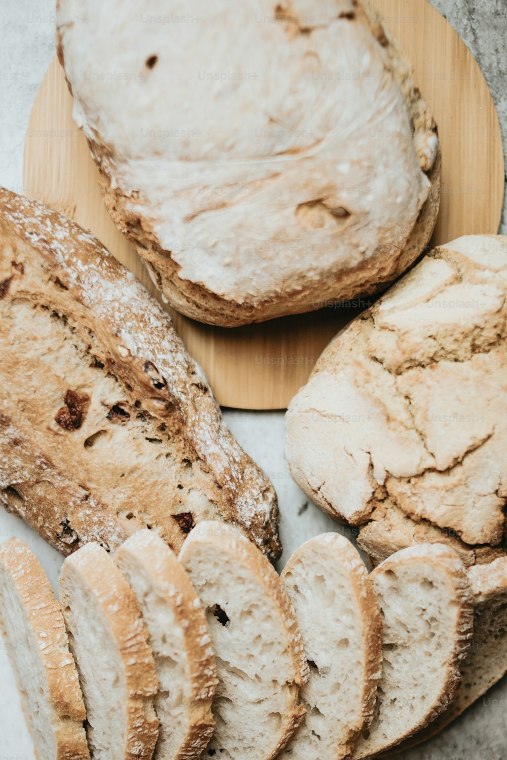 a wooden plate topped with loaves of bread