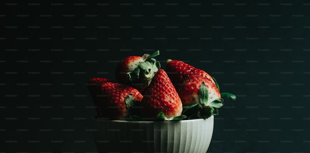 a close up of a bowl of strawberries