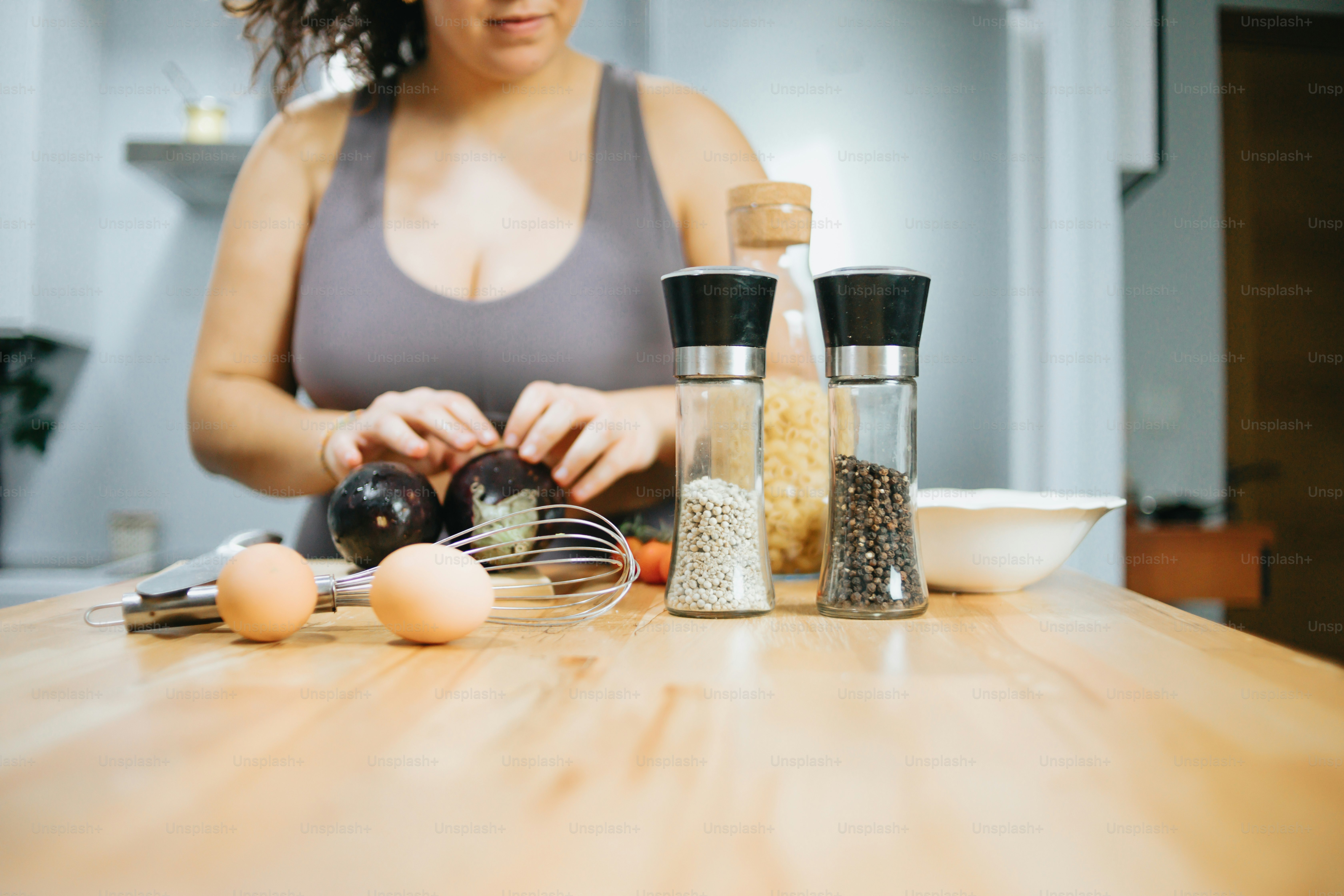 a woman preparing food on a wooden table
