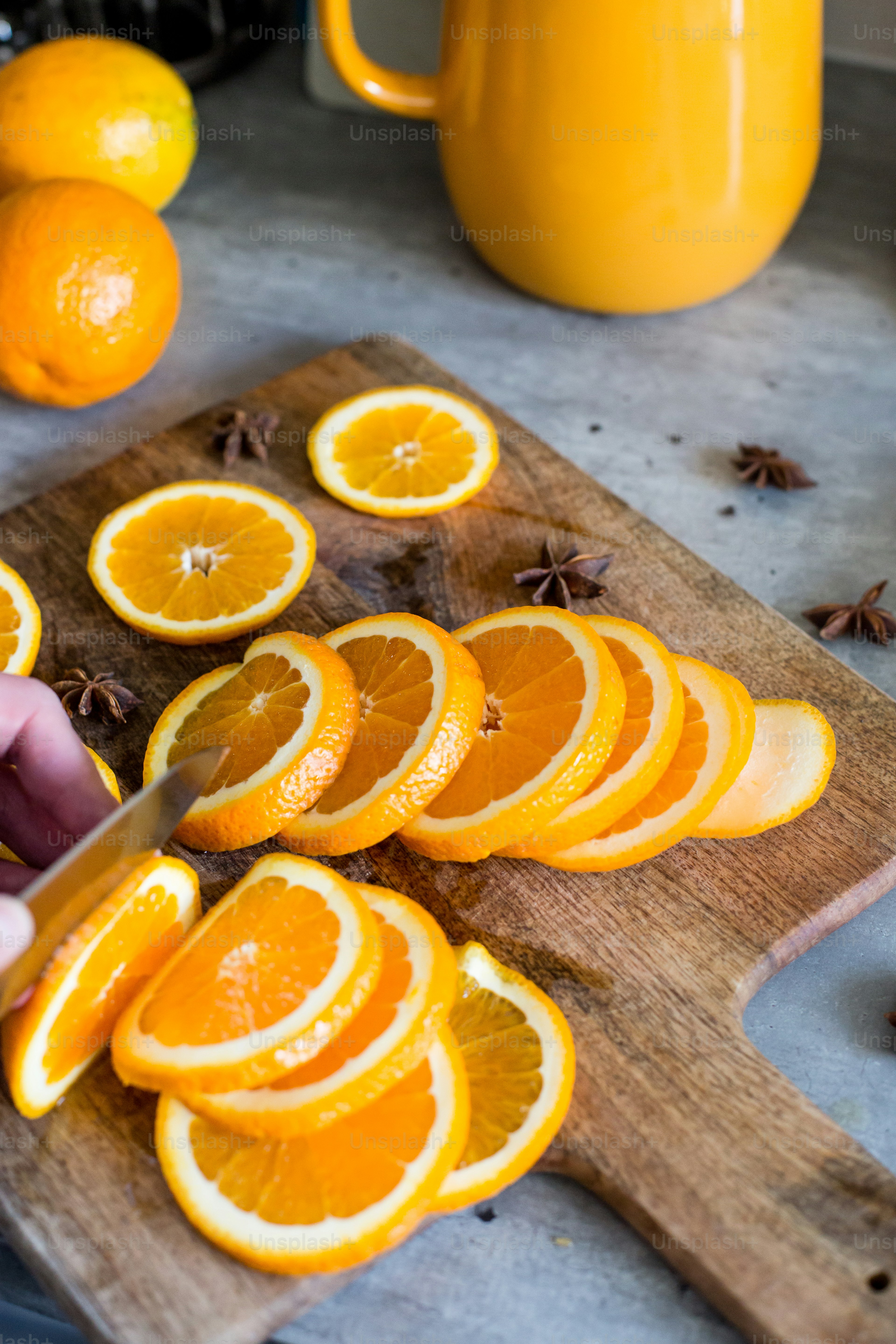a person slicing oranges on a cutting board