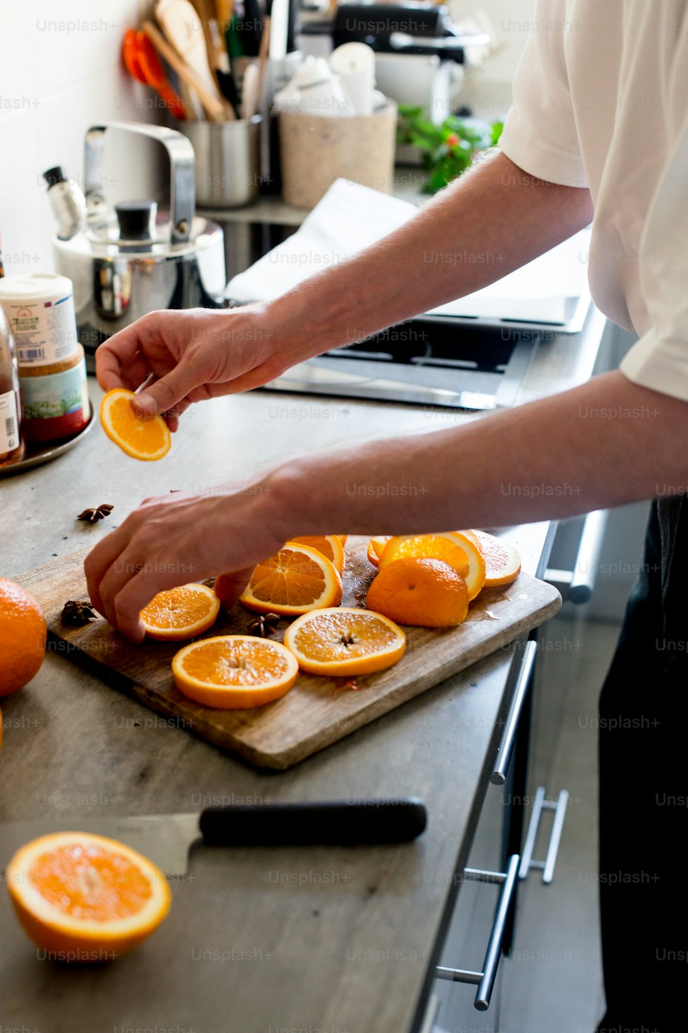 a person is peeling an orange on a cutting board