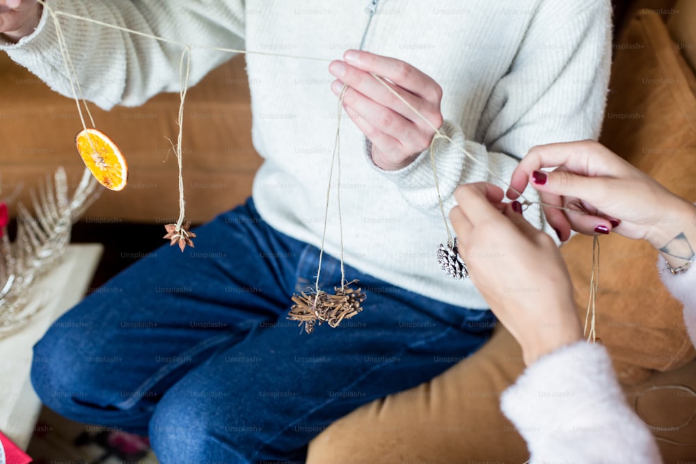 two people sitting on a couch with christmas decorations