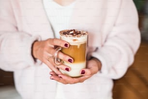 a woman holding a drink in her hands