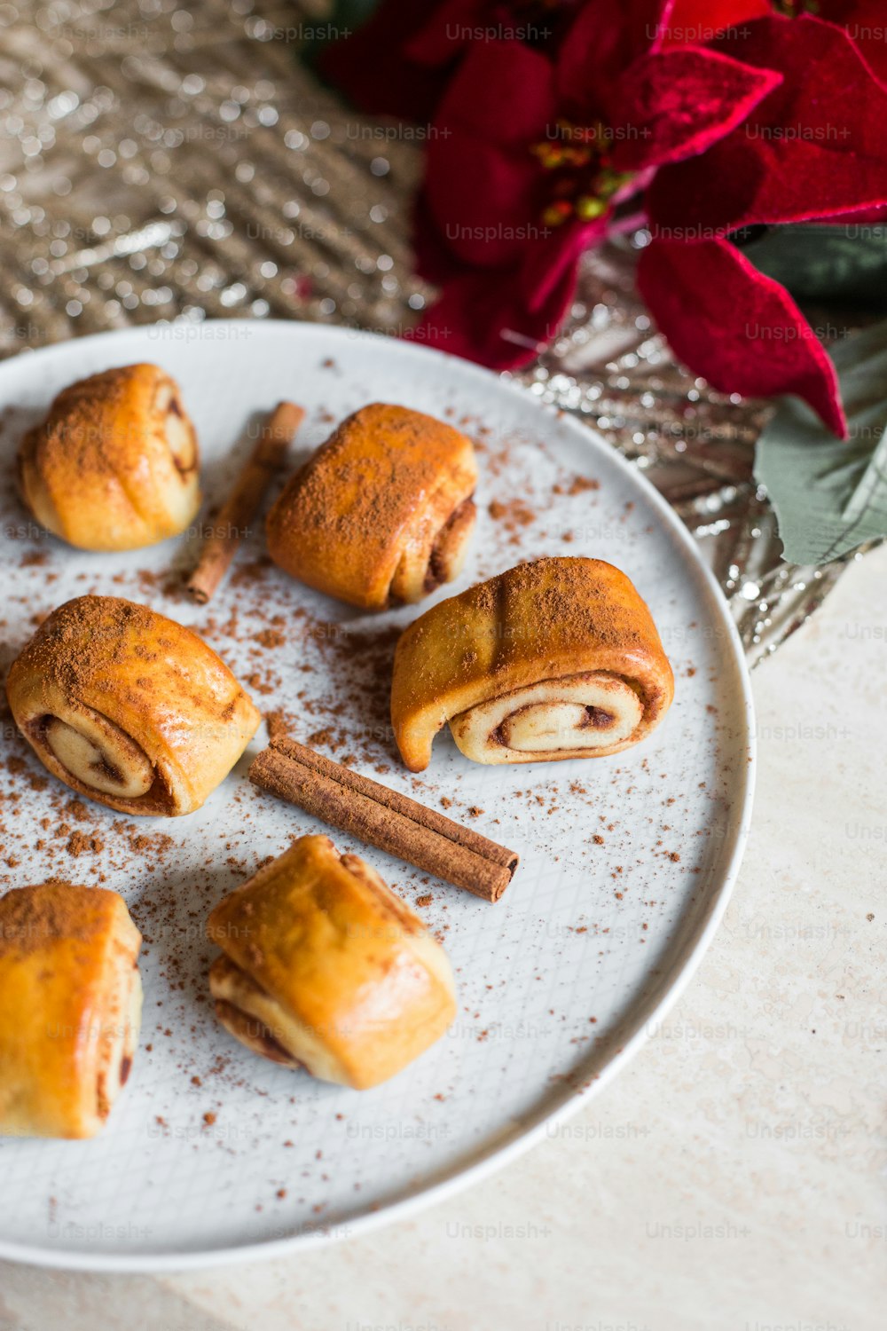 a white plate topped with pastries and cinnamon sticks