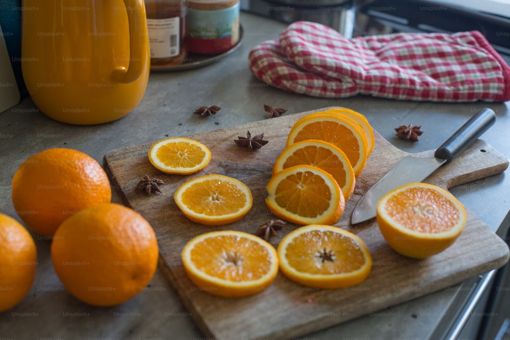 a wooden cutting board topped with sliced oranges
