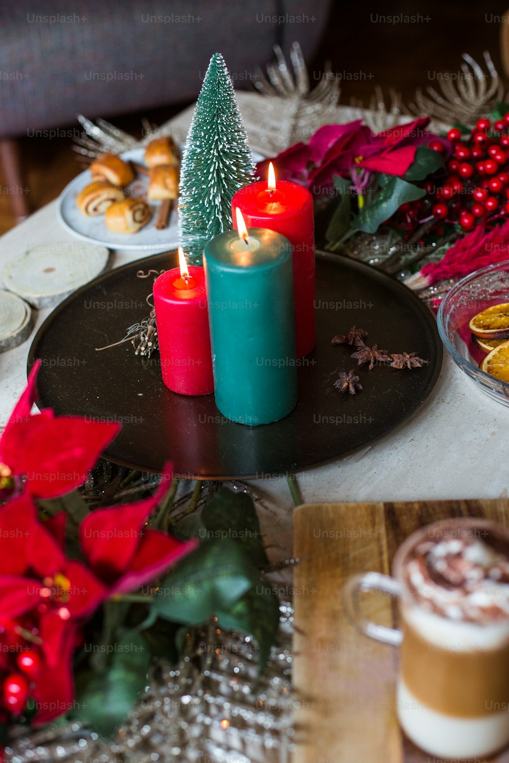 a table topped with a plate of food and two candles