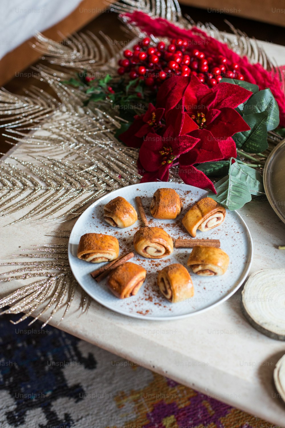 a white plate topped with pastries next to a christmas tree