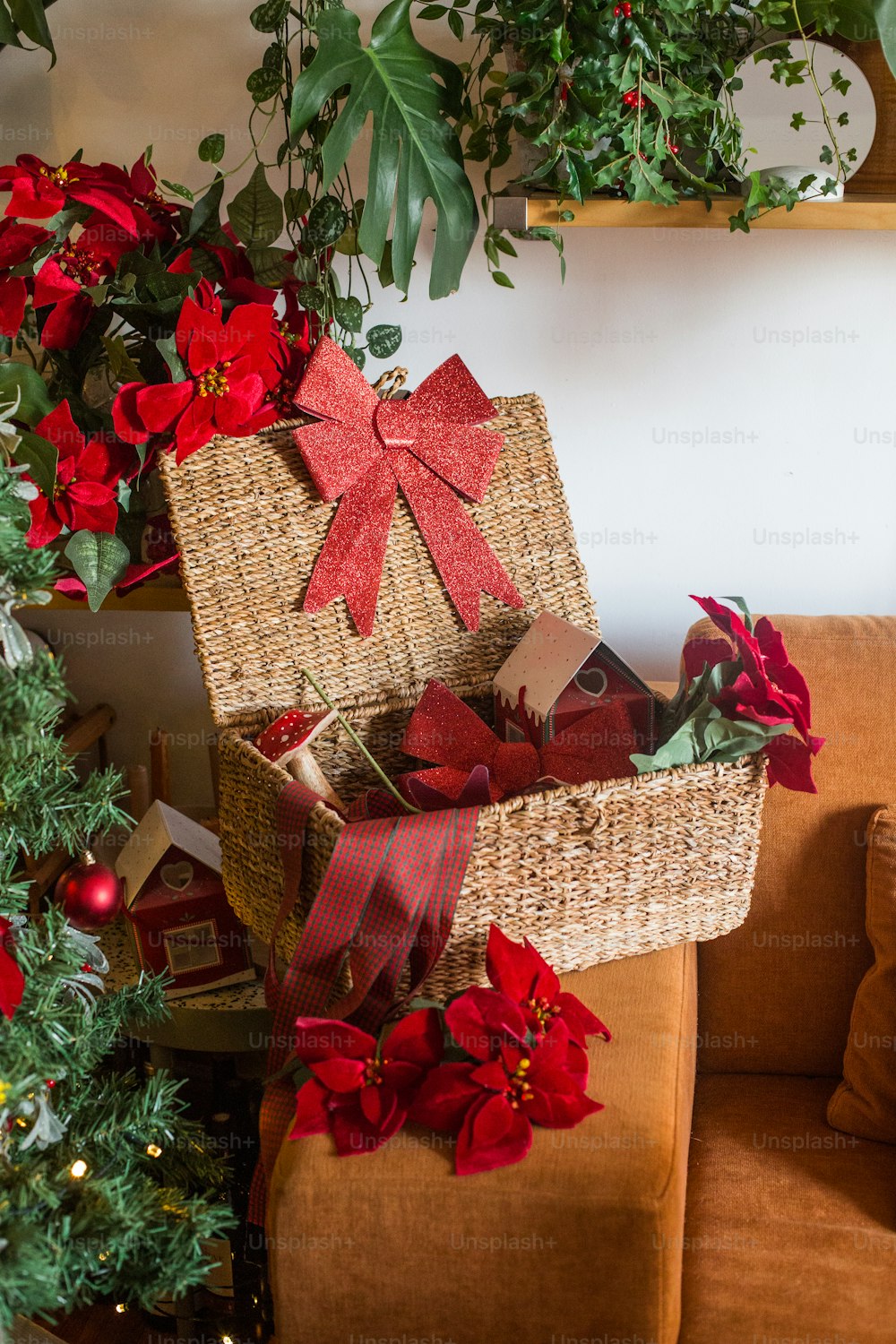 a wicker basket with a red ribbon and poinsettis