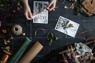 a person holding a piece of paper next to other items