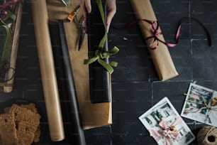 a person holding a flower on top of a table