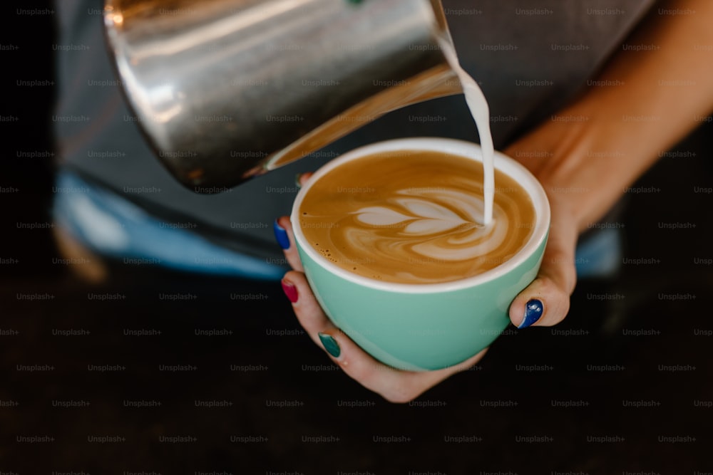 a woman is pouring a cup of coffee