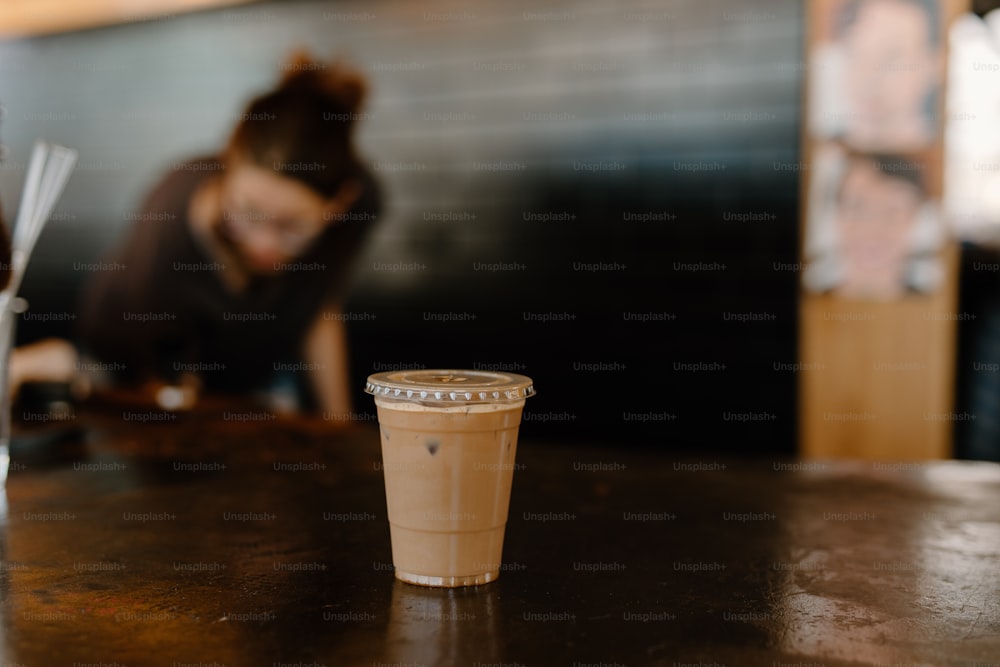 a cup of coffee sitting on top of a table