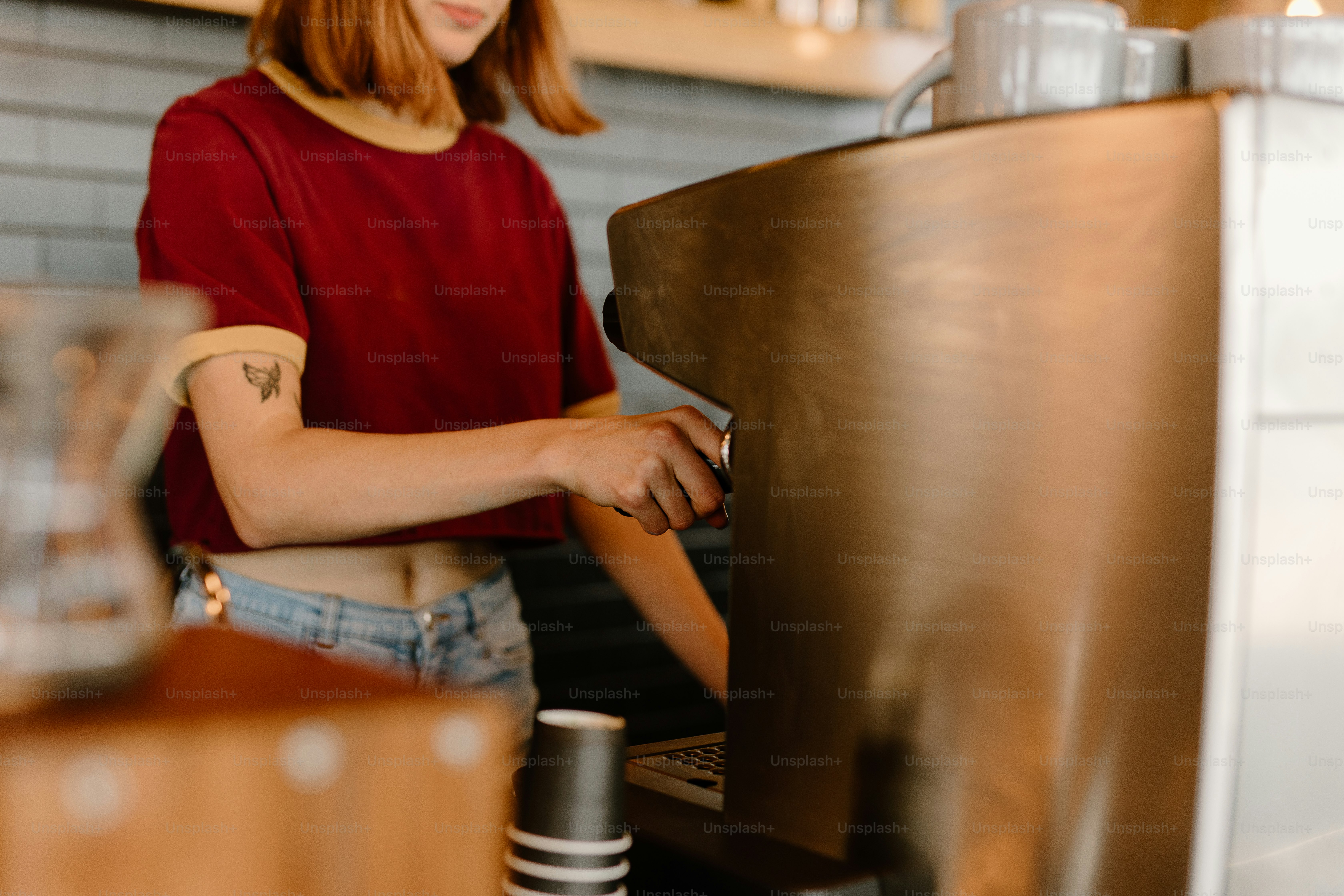 a woman in a red shirt is working on a laptop