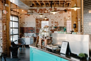 a coffee shop with a brick wall and a blue counter