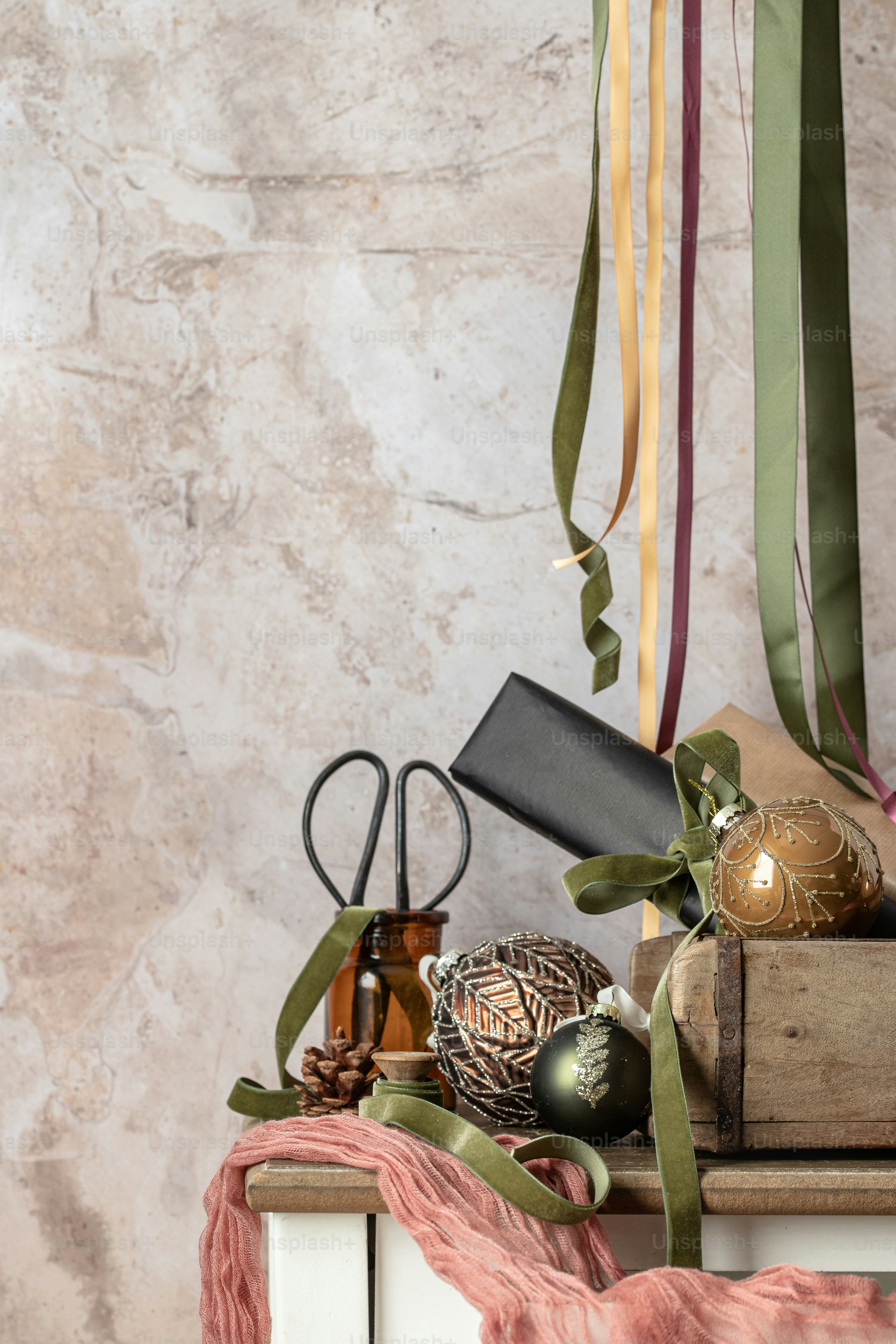 a table topped with a pile of books covered in ribbons
