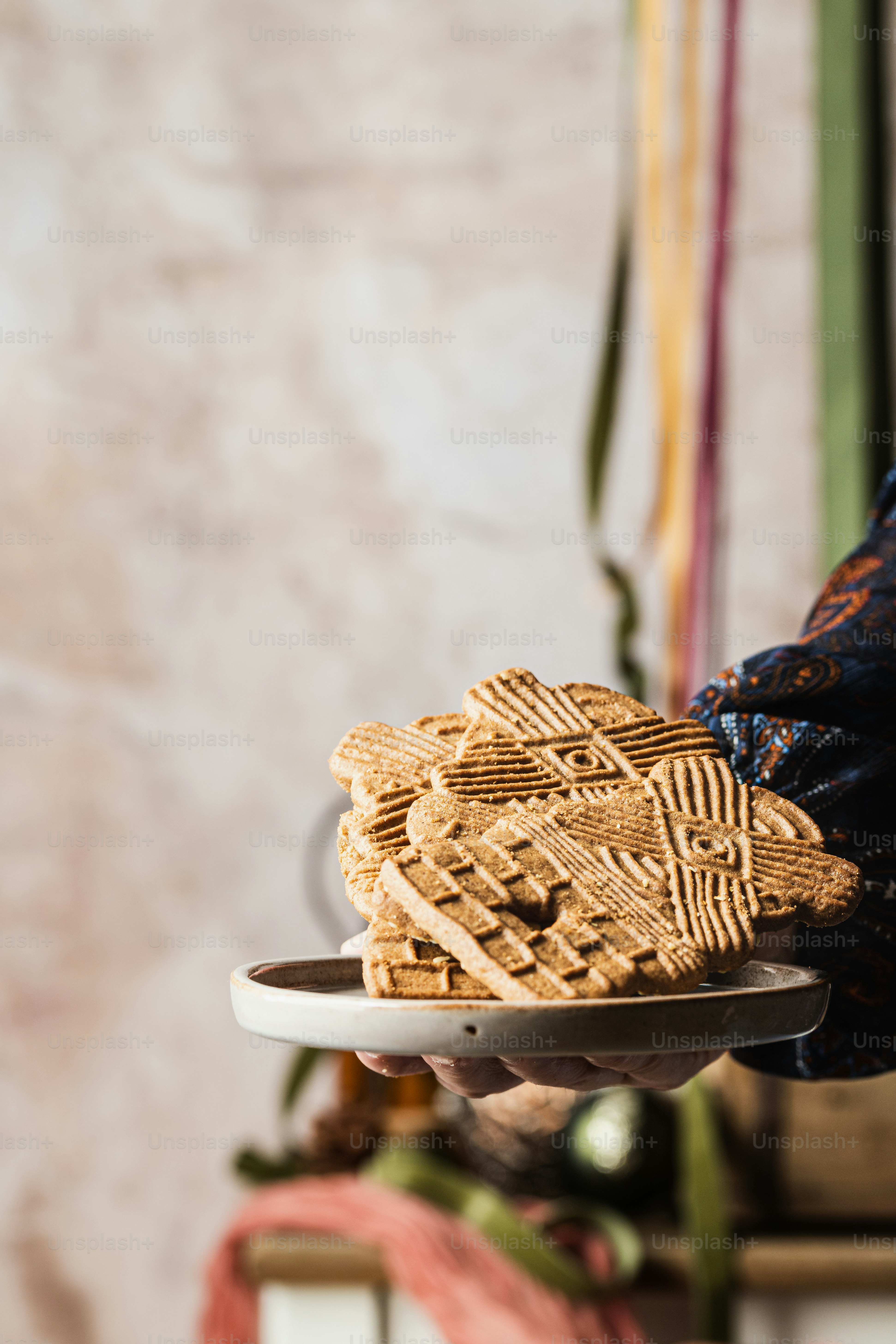 a person holding a plate with cookies on it