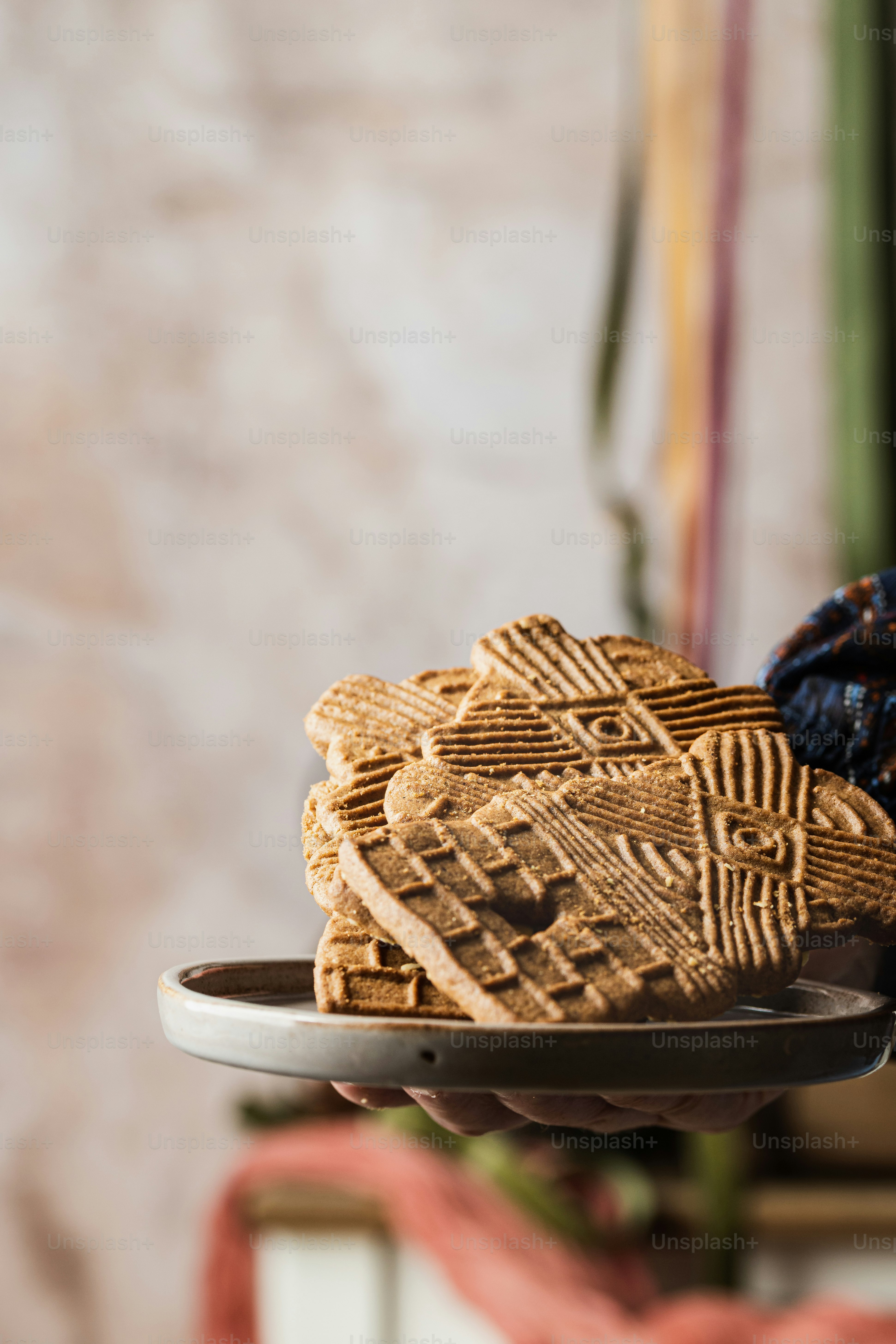 a person holding a plate with some cookies on it