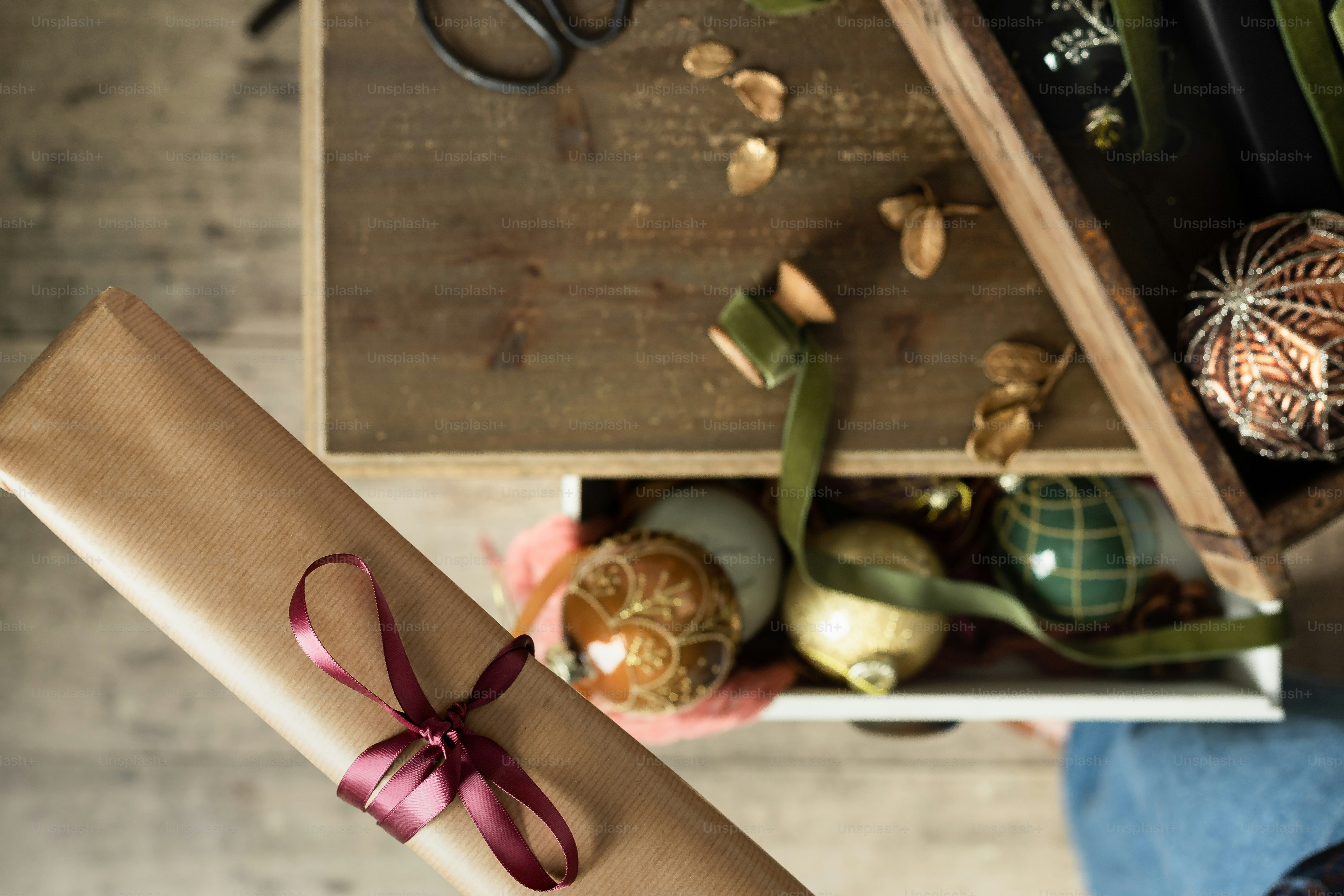 a gift wrapped in brown paper with a pink ribbon