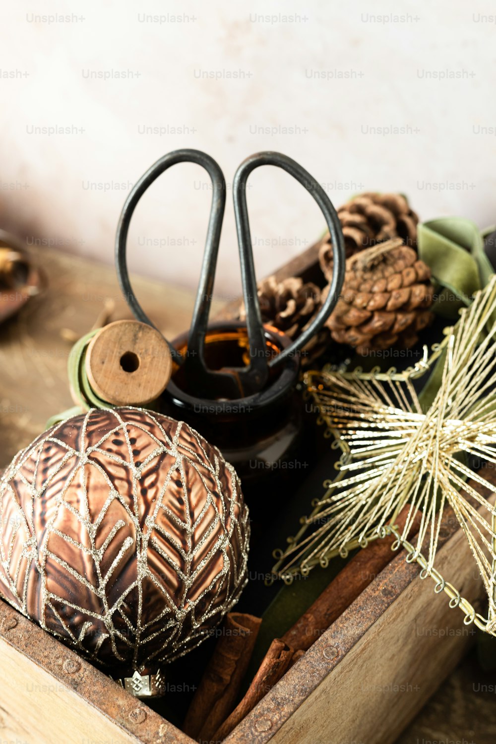 a wooden box filled with pine cones and a pair of scissors