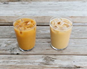 two drinks sitting on top of a wooden table