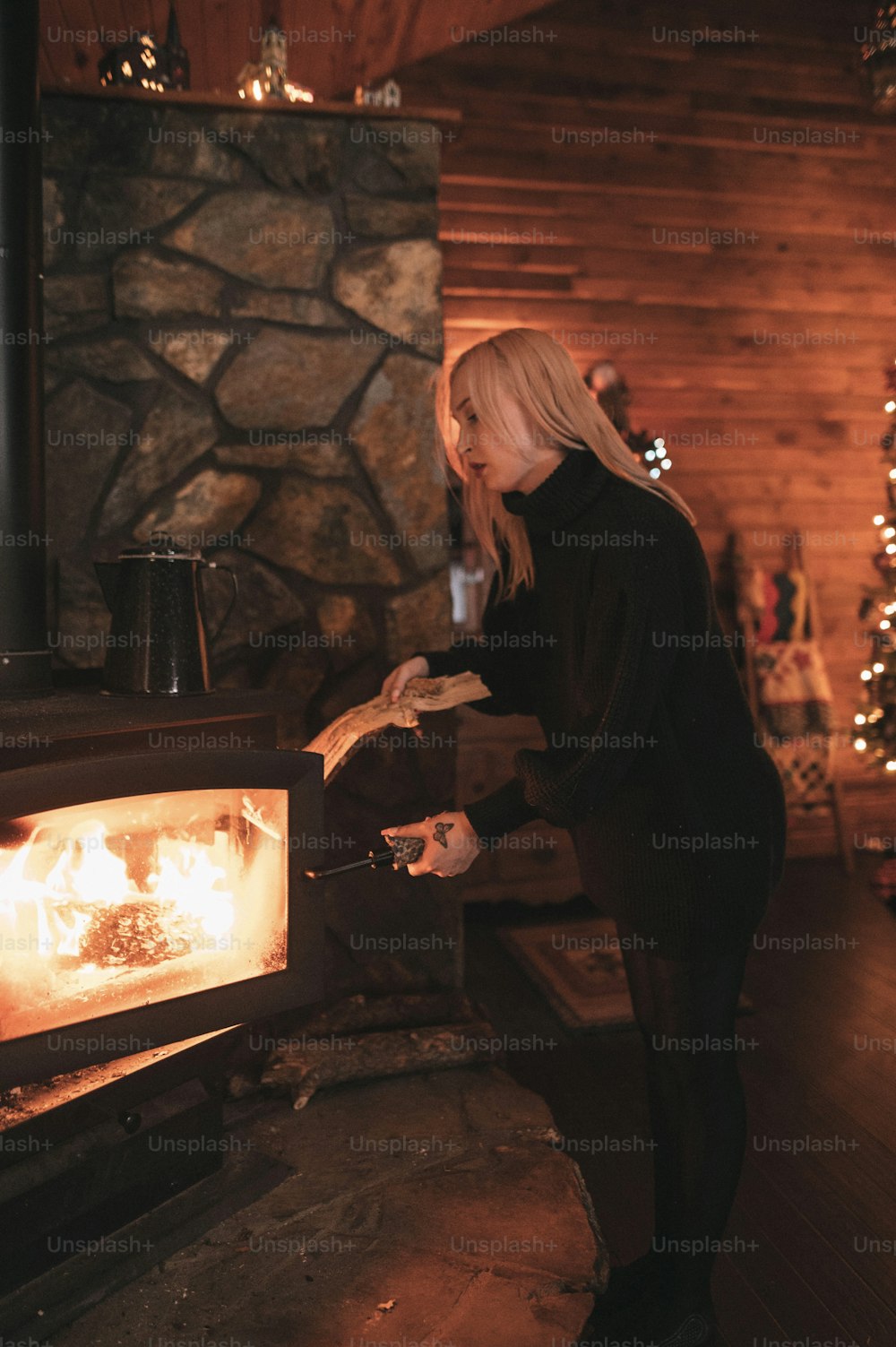 a woman standing in front of an open fire