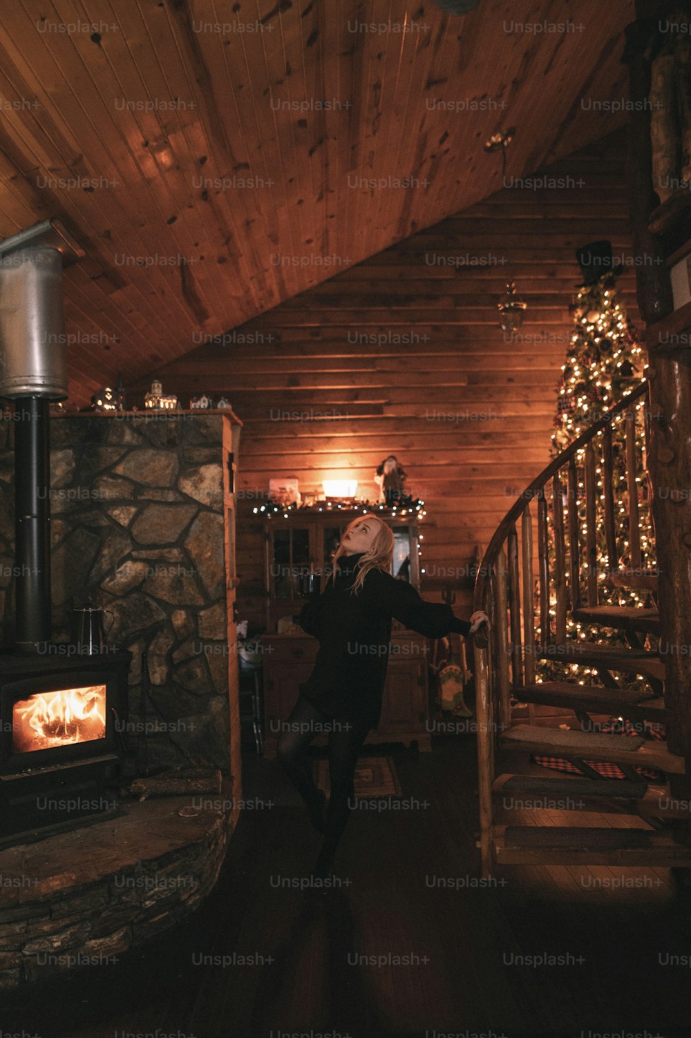 a woman taking a picture of herself in a cabin