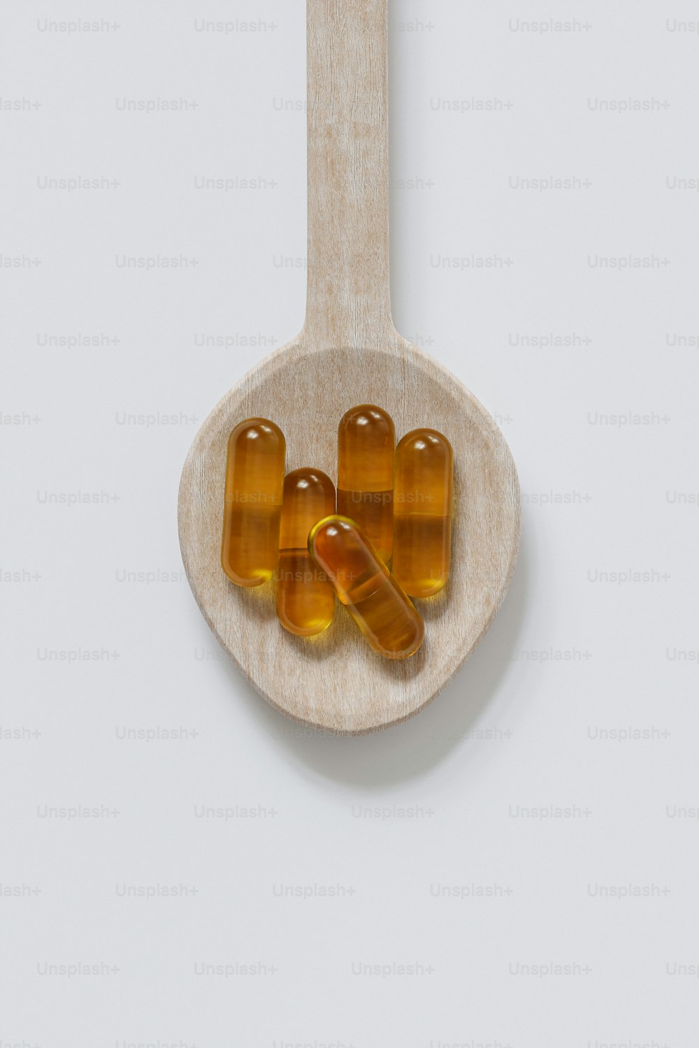 a spoon with some pills on it