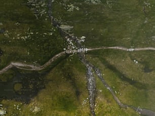 an aerial view of a grassy area with a river running through it