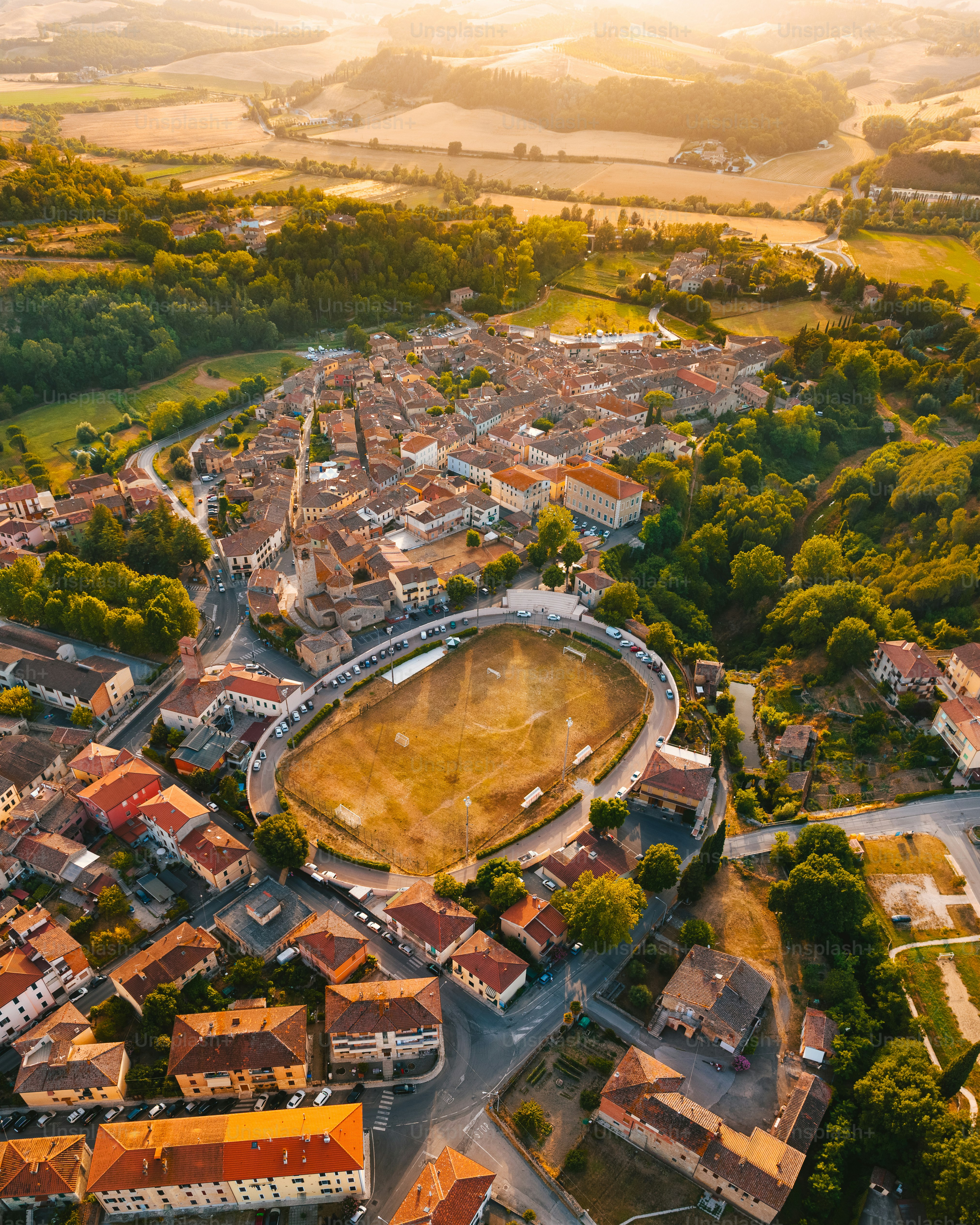 an aerial view of a city with a large field