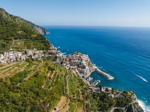 an aerial view of a village on the edge of a cliff