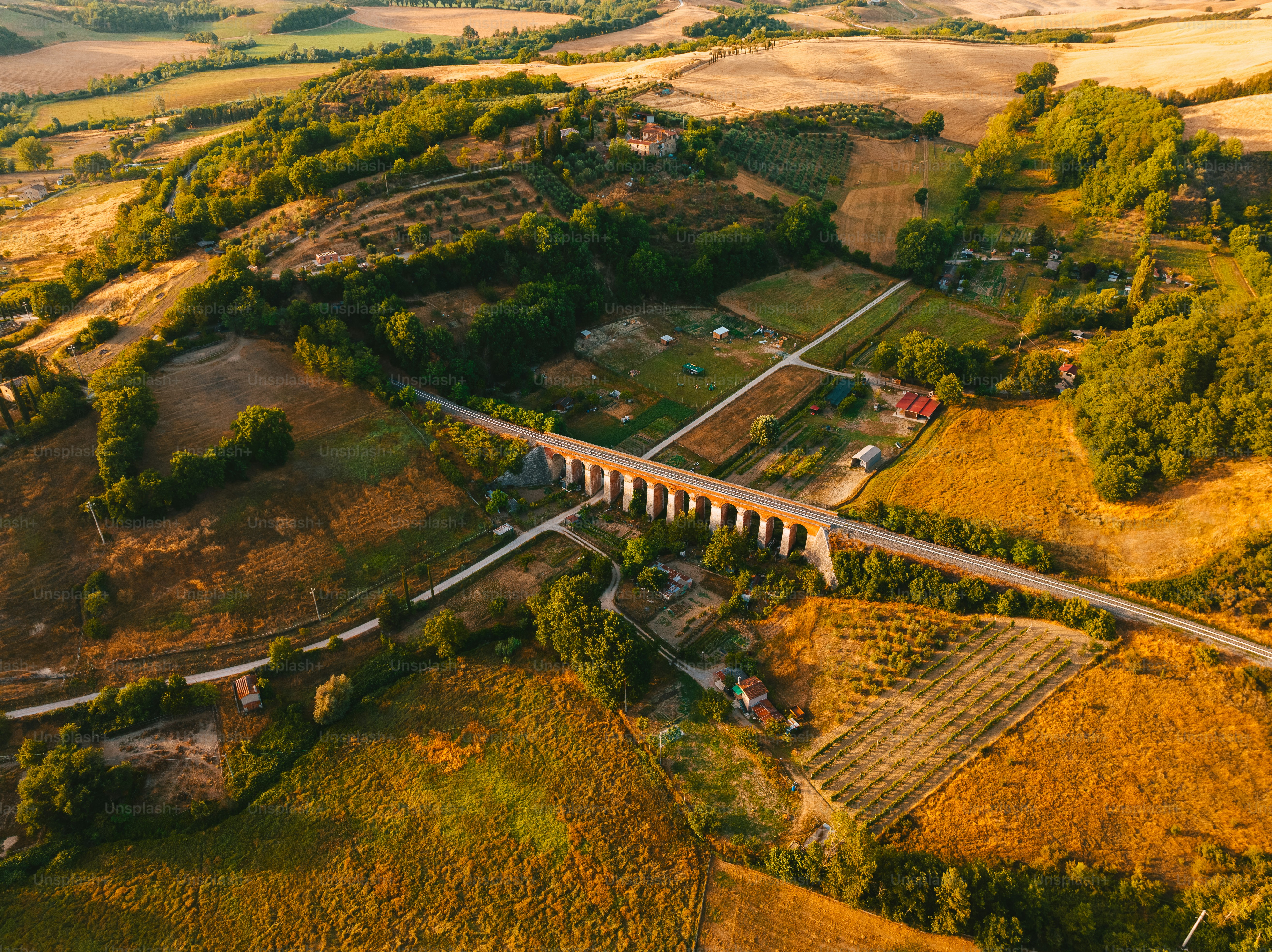 an aerial view of a bridge in the countryside