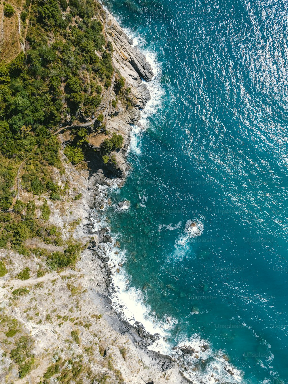 a bird's eye view of the ocean and cliffs