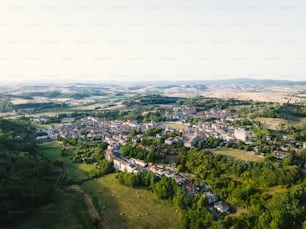 an aerial view of a town surrounded by trees