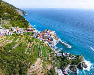 an aerial view of a village on the edge of a cliff